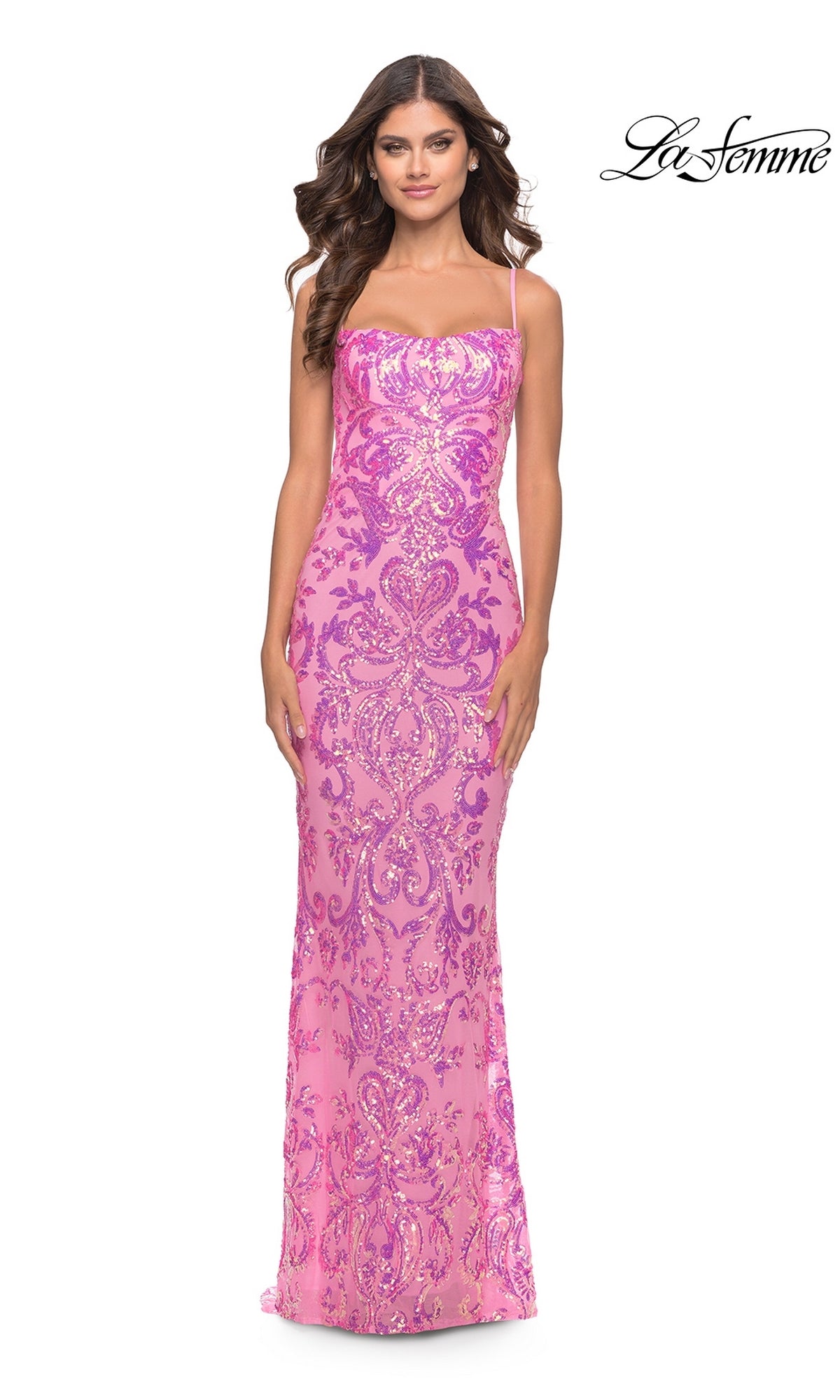 A woman in a neon pink, open-back long sequin prom dress (La Femme 31521) with a fitted silhouette and intricate pattern stands against a white background. The La Femme logo appears in the top right corner.